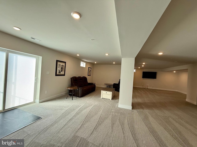 unfurnished living room with light colored carpet