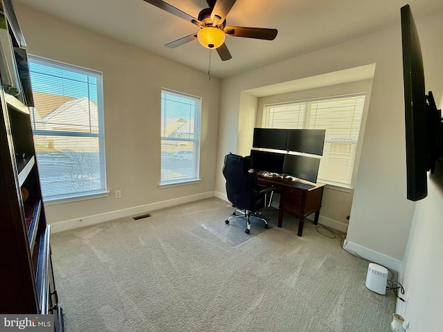 office space with light colored carpet and ceiling fan