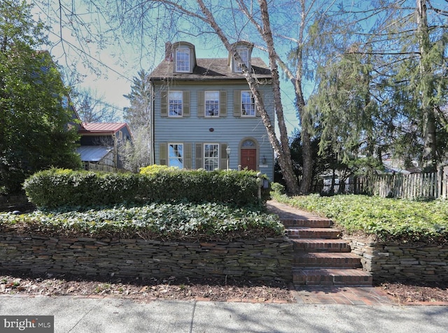 colonial home with fence