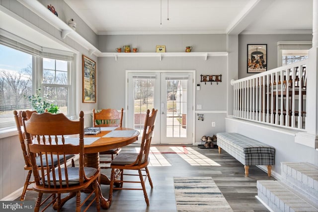 dining space with french doors, a healthy amount of sunlight, wood finished floors, and crown molding