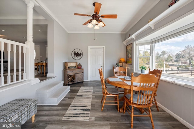 dining room featuring baseboards, a ceiling fan, wood finished floors, and crown molding