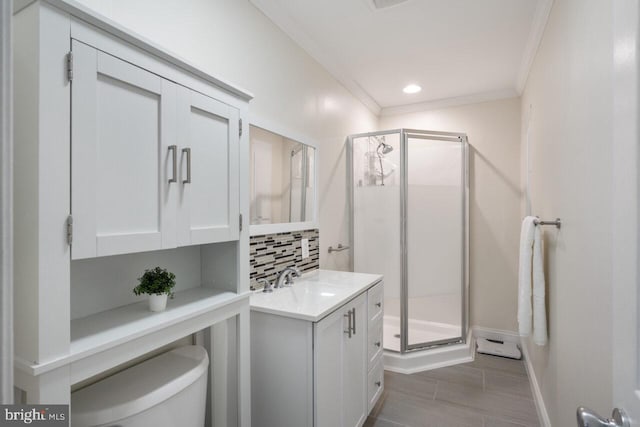 bathroom featuring decorative backsplash, a shower stall, vanity, and ornamental molding