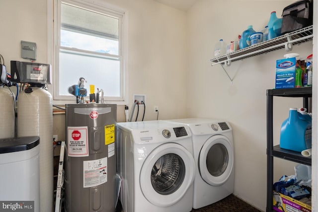 washroom with separate washer and dryer, electric water heater, and laundry area