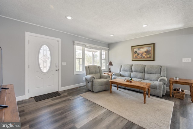 living room featuring dark wood-type flooring, recessed lighting, baseboards, and a textured ceiling