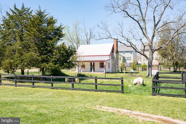 view of front of house featuring a fenced front yard, metal roof, and a front yard