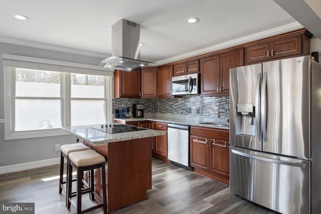 kitchen with a kitchen island, crown molding, decorative backsplash, appliances with stainless steel finishes, and island range hood