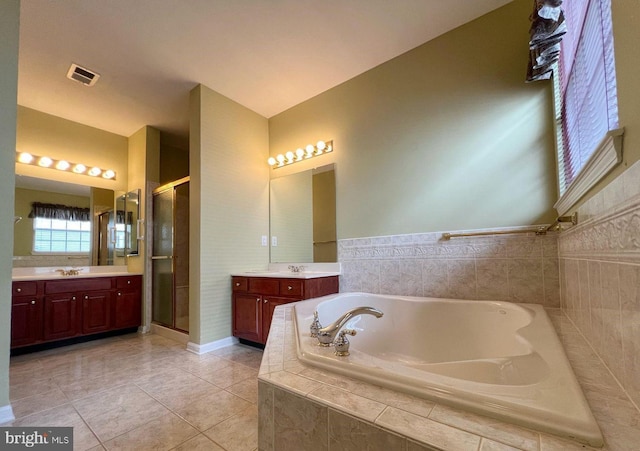 bathroom with vanity, tile patterned floors, and shower with separate bathtub