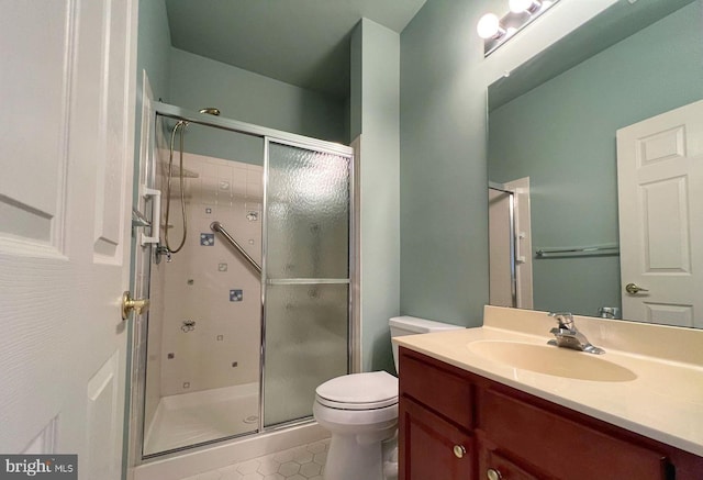 bathroom featuring vanity, tile patterned flooring, a shower with door, and toilet