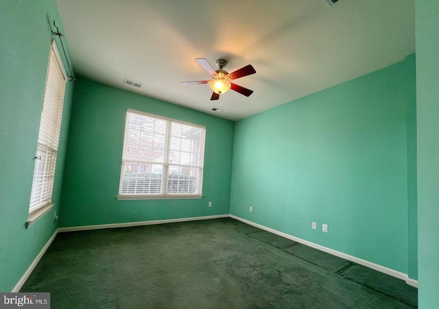 carpeted spare room with ceiling fan