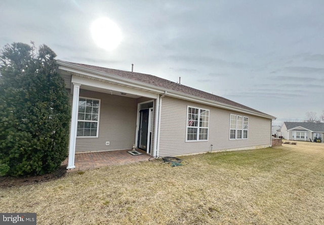 rear view of property with a yard and a patio area