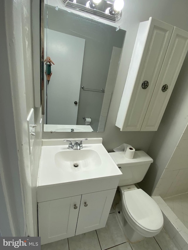 bathroom featuring vanity, tile patterned floors, and toilet