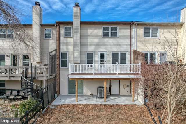 rear view of property with a patio area and cooling unit