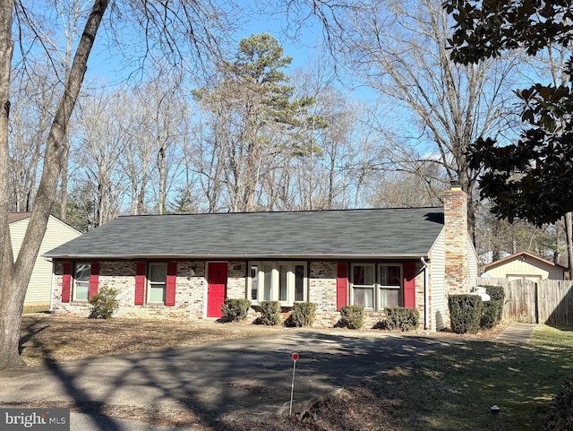 single story home featuring a storage shed