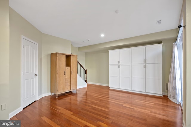 interior space with recessed lighting, visible vents, light wood-style flooring, baseboards, and stairs