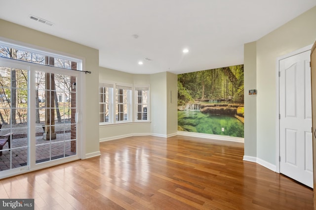 interior space with recessed lighting, wood finished floors, visible vents, and baseboards