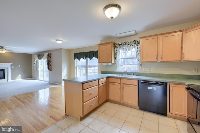 kitchen with range, light brown cabinetry, sink, black dishwasher, and kitchen peninsula