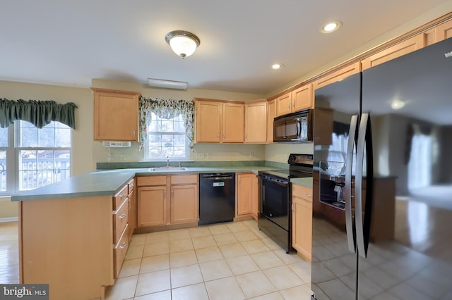 kitchen with sink, black appliances, light brown cabinetry, and a healthy amount of sunlight