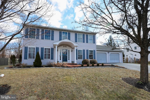 colonial house with a garage and a front lawn