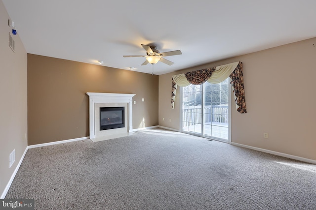 unfurnished living room featuring carpet floors and ceiling fan