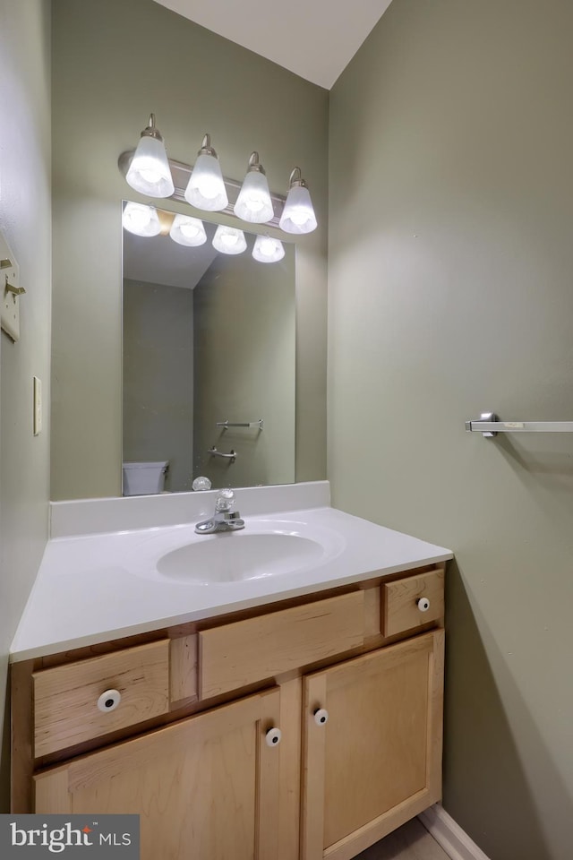 bathroom featuring toilet and vanity