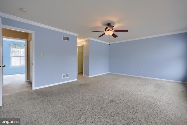 unfurnished room with ceiling fan, crown molding, and light colored carpet