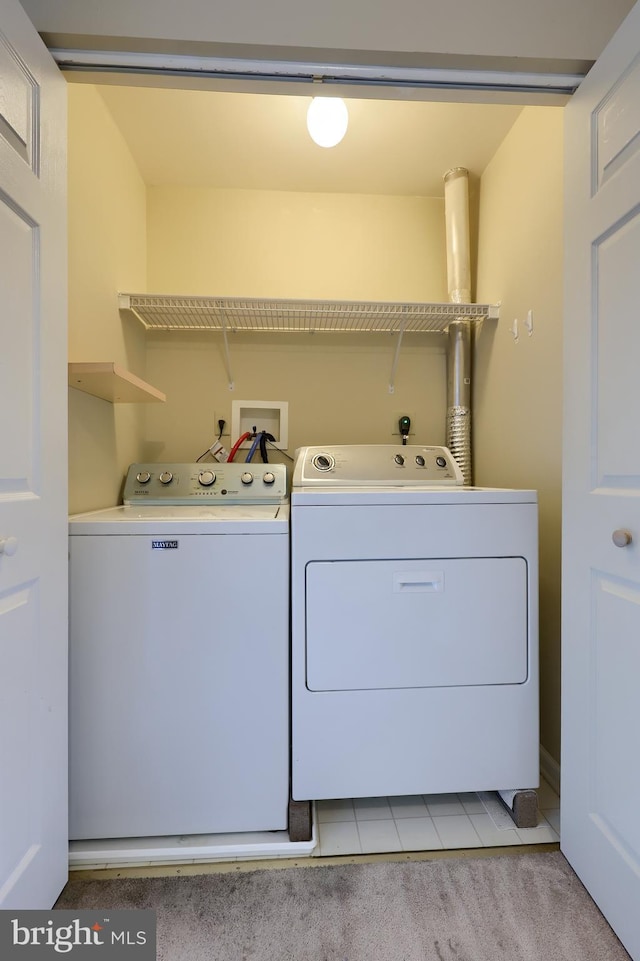 washroom featuring washing machine and clothes dryer and light carpet