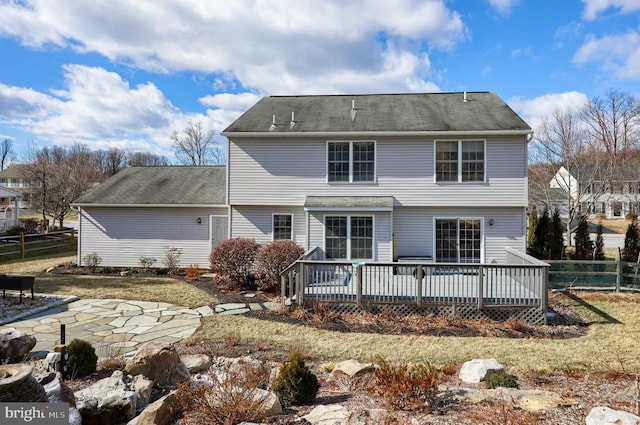 rear view of property with a deck and a patio area