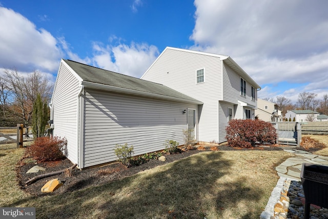 view of property exterior with a lawn