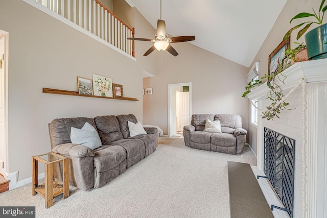 carpeted living room featuring high vaulted ceiling, a brick fireplace, ceiling fan, and baseboards