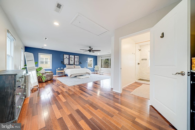 bedroom featuring hardwood / wood-style flooring, attic access, visible vents, and recessed lighting