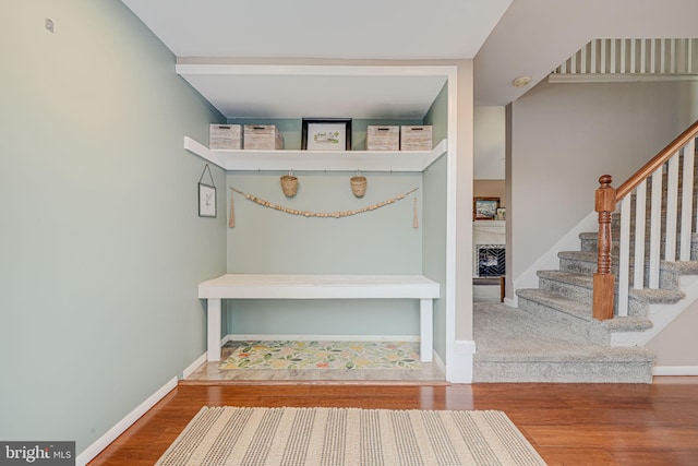 mudroom featuring baseboards and wood finished floors