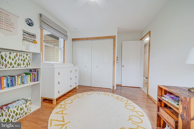 interior space with baseboards, a closet, a ceiling fan, and wood finished floors