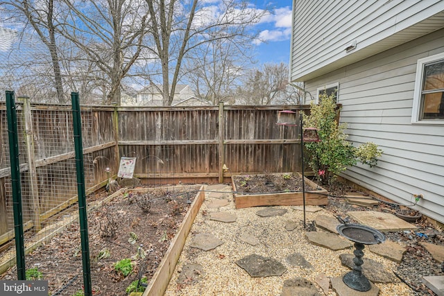 view of yard featuring a vegetable garden and fence