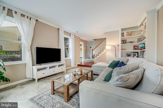 living area with built in shelves, crown molding, baseboards, and stairs