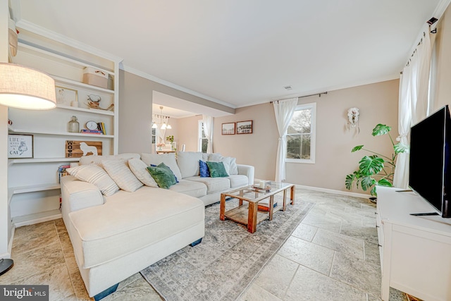 living room with a chandelier, baseboards, stone tile flooring, and crown molding