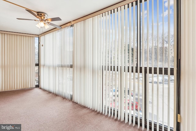 unfurnished sunroom with a ceiling fan