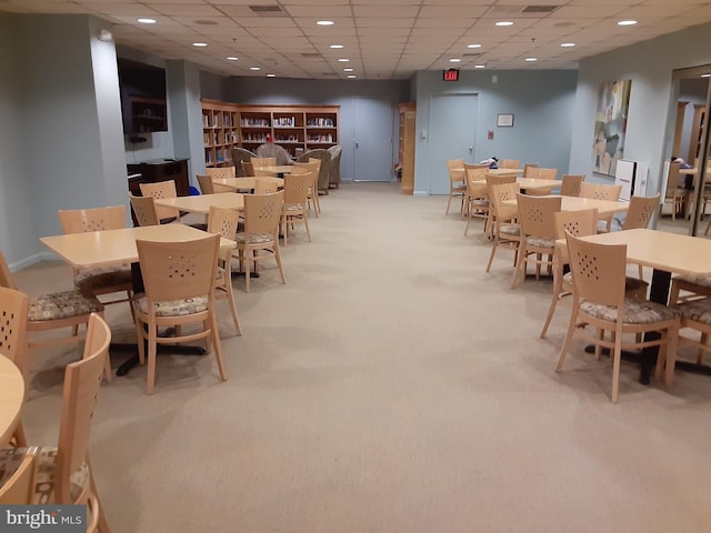 dining space with light carpet, a paneled ceiling, and recessed lighting