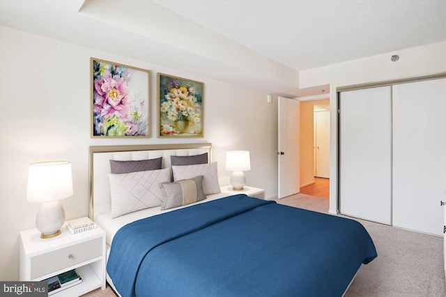 bedroom featuring a closet and light colored carpet