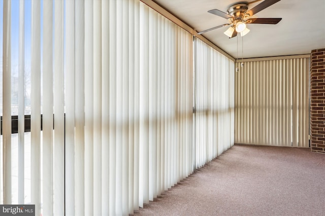 unfurnished sunroom with ceiling fan