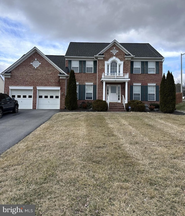 view of front of home with a front yard and a garage