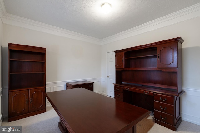 unfurnished office featuring light carpet, ornamental molding, and a wainscoted wall