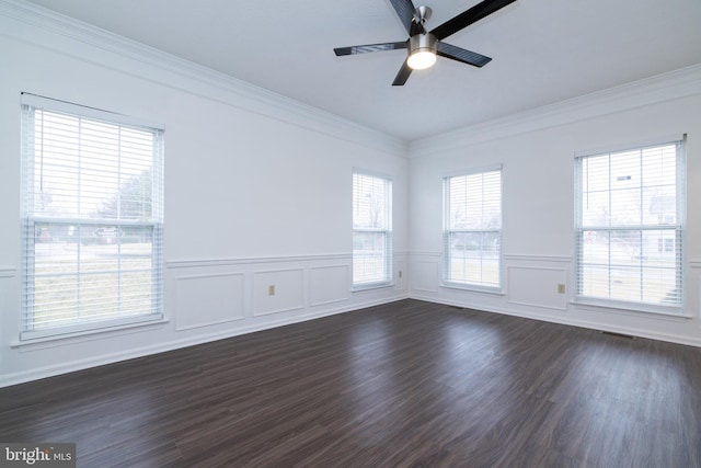 unfurnished room with visible vents, dark wood-style floors, ceiling fan, a wainscoted wall, and ornamental molding