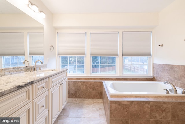 full bath with vanity and a bath
