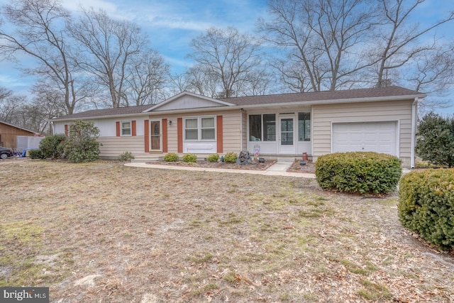 ranch-style home with a front yard and an attached garage