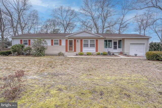 ranch-style house with an attached garage and a front lawn