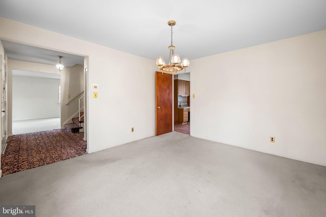 interior space with carpet flooring, an inviting chandelier, and stairs