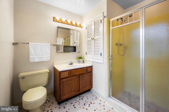 bathroom with vanity, baseboards, tile patterned flooring, toilet, and a shower stall