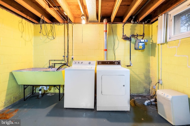 washroom with a sink, washer and clothes dryer, and laundry area