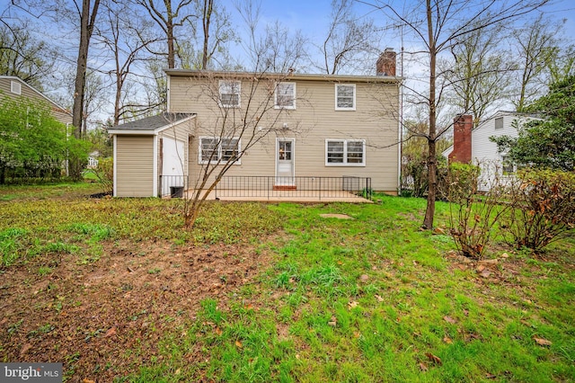 rear view of property featuring a patio and a chimney
