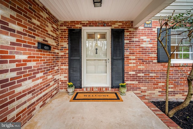 property entrance with brick siding